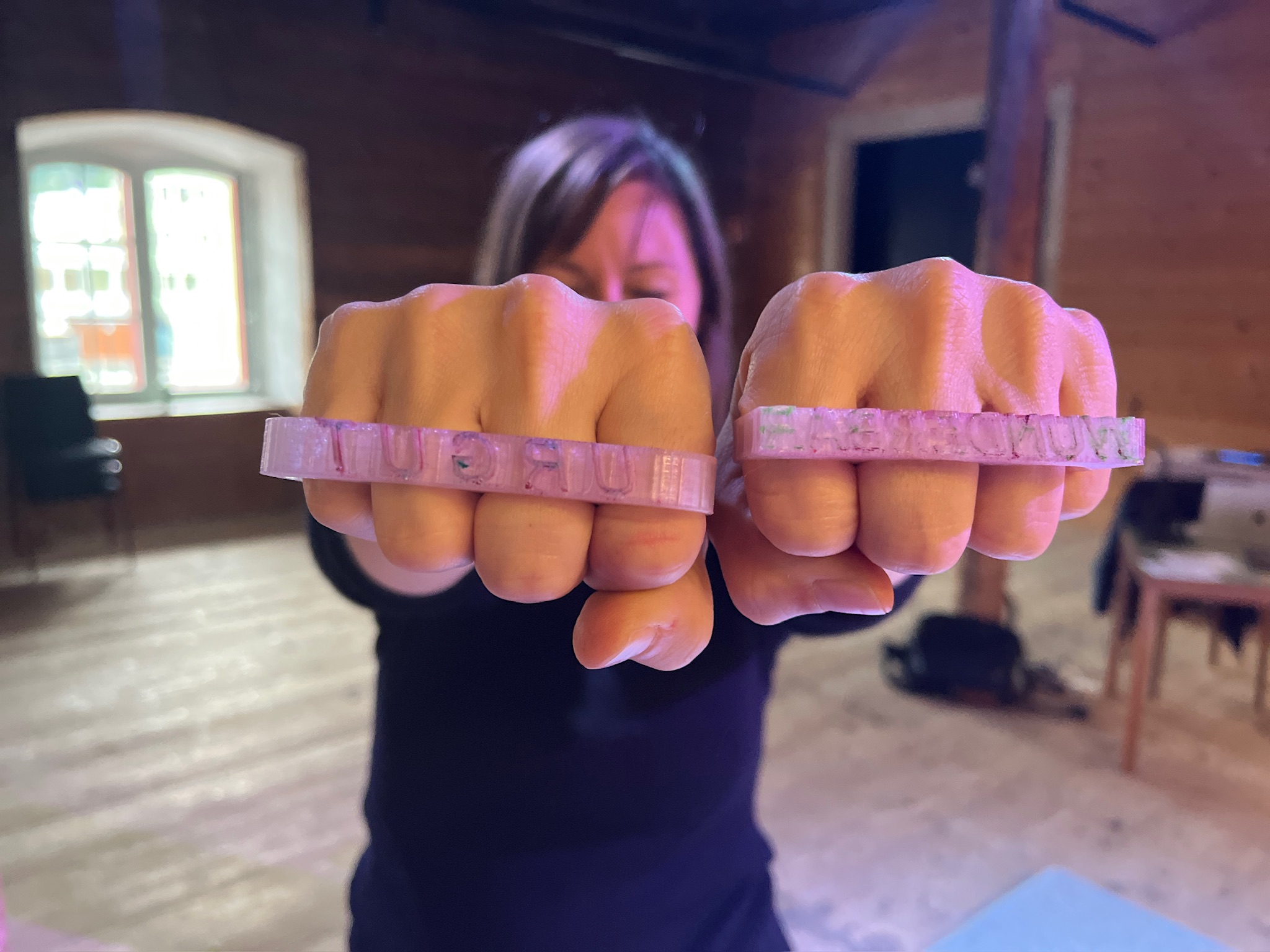 Artist wearing brass-knuckle stamps